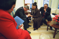 President George W. Bush joins in prayer with Coretta Scott King, left, Bernice King and Martin Luther King III during their visit to the Oval Office. Jan 21, 2002.