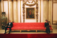 President George W. Bush and Mrs. Laura Bush playfully sit on either ends of a couch prior to a social event at Buckingham Palace. Nov. 20, 2003. 