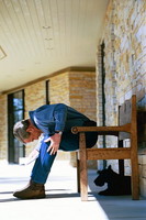 President George W. Bush discovers his dog Barney sitting under his bench. Crawford, Texas, March 6, 2004.